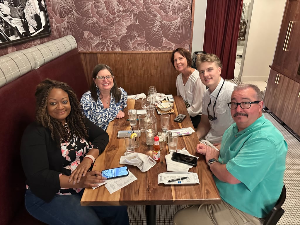 Five Athens locals gathered around a Dinner Club table